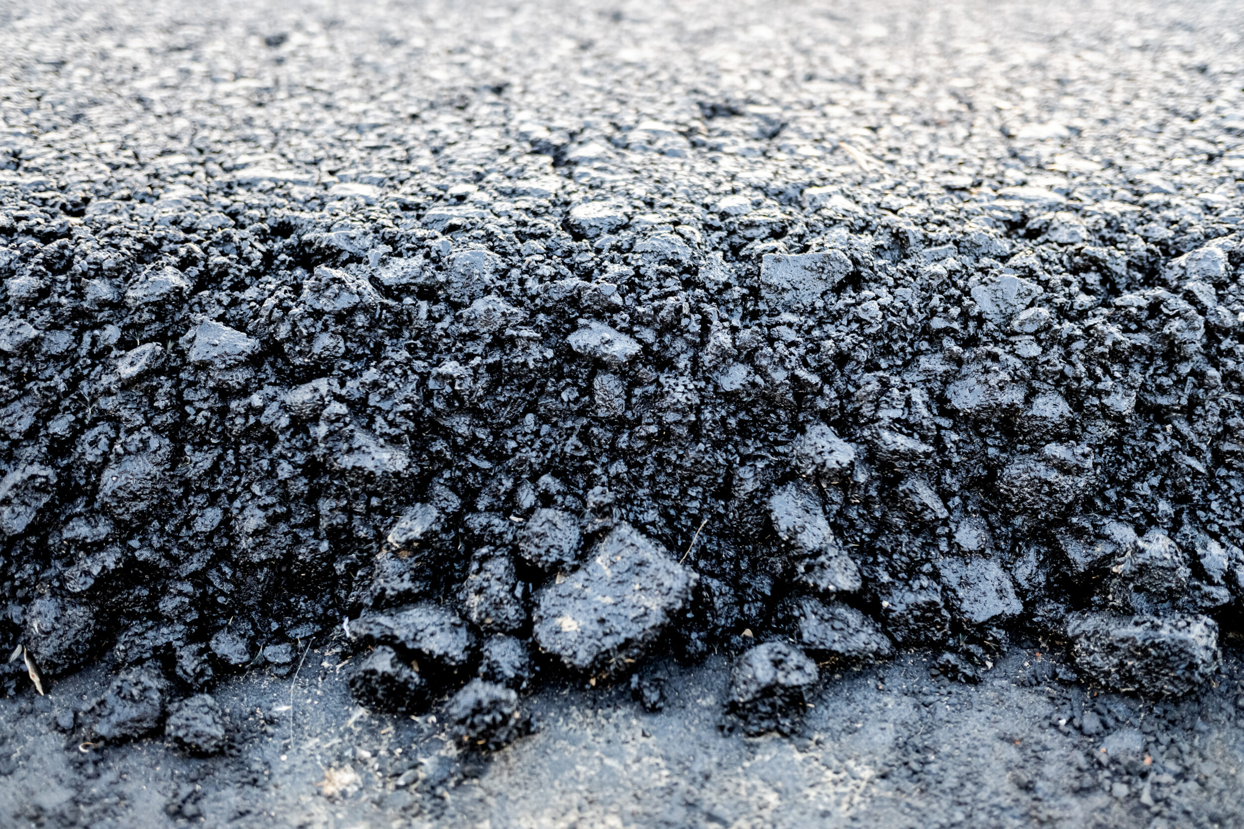 asphalt layer just spread on a new road detail 2023 11 27 05 27 19 utc