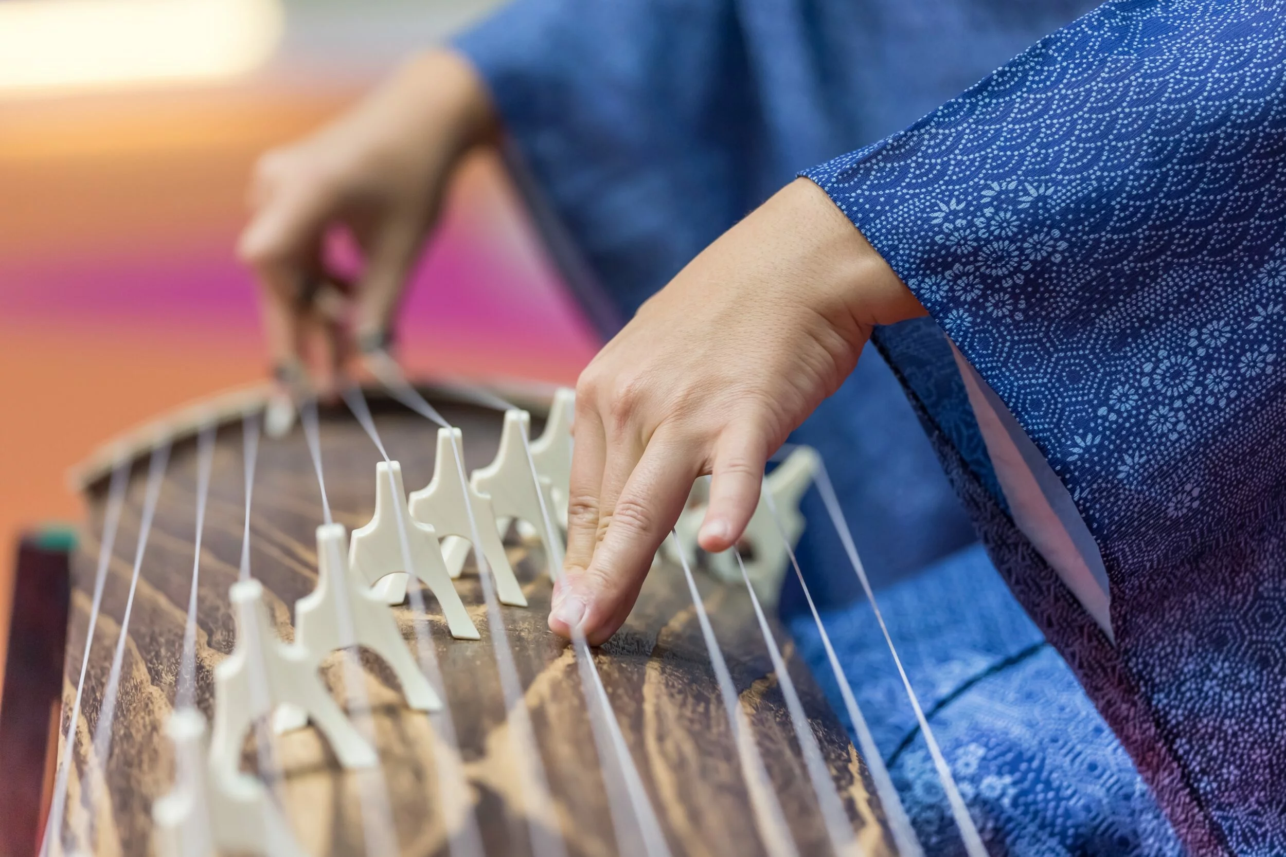 woman playing japanese harp koto hands in frame 2023 11 27 05 10 08 utc